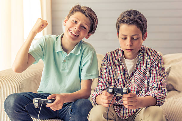 Two boys gaming on couch